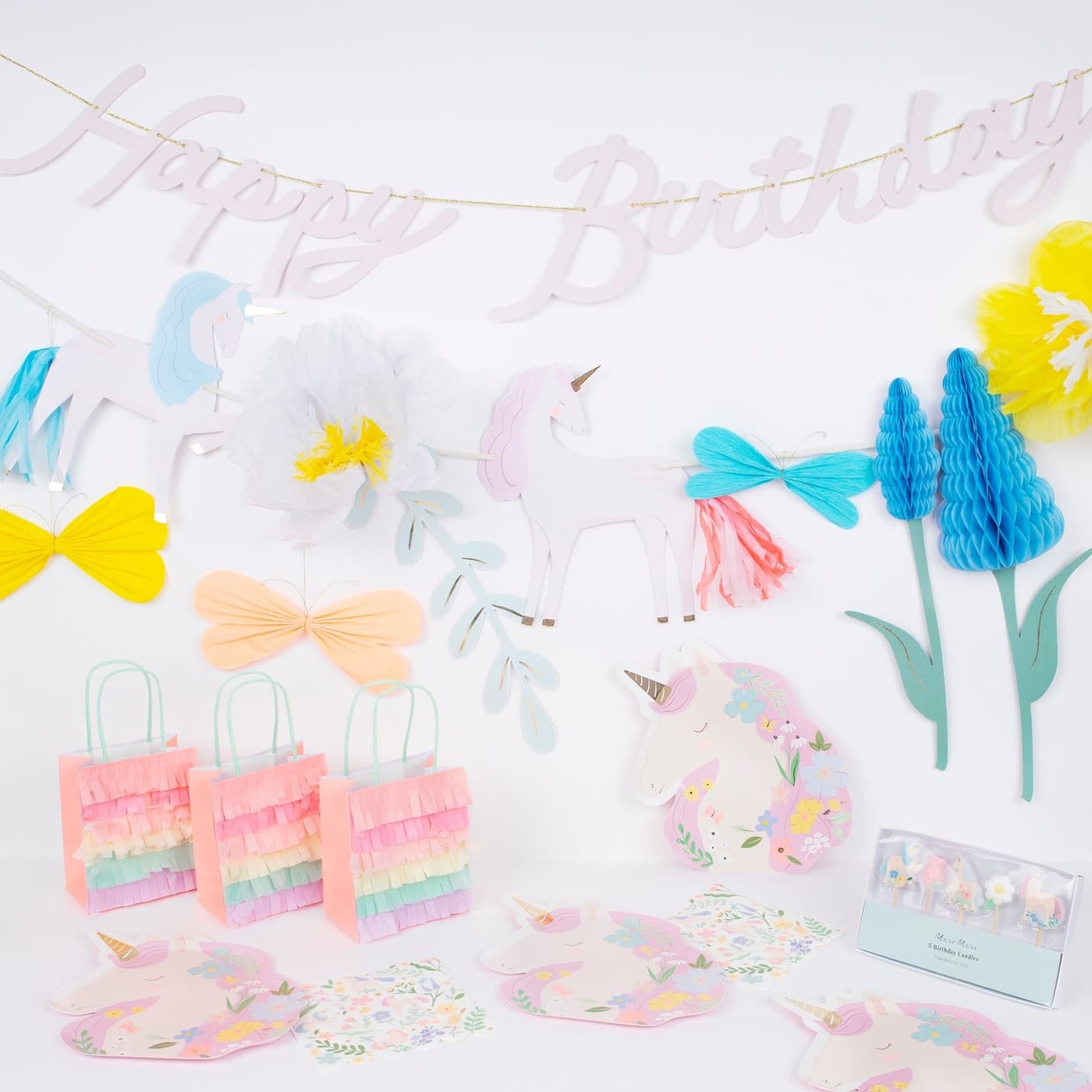 Meri Meri Meadow Unicorns party set with plates, napkins, bags, and garland